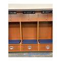 UConn wooden locker room lockers with blue seats and team logos on a white background