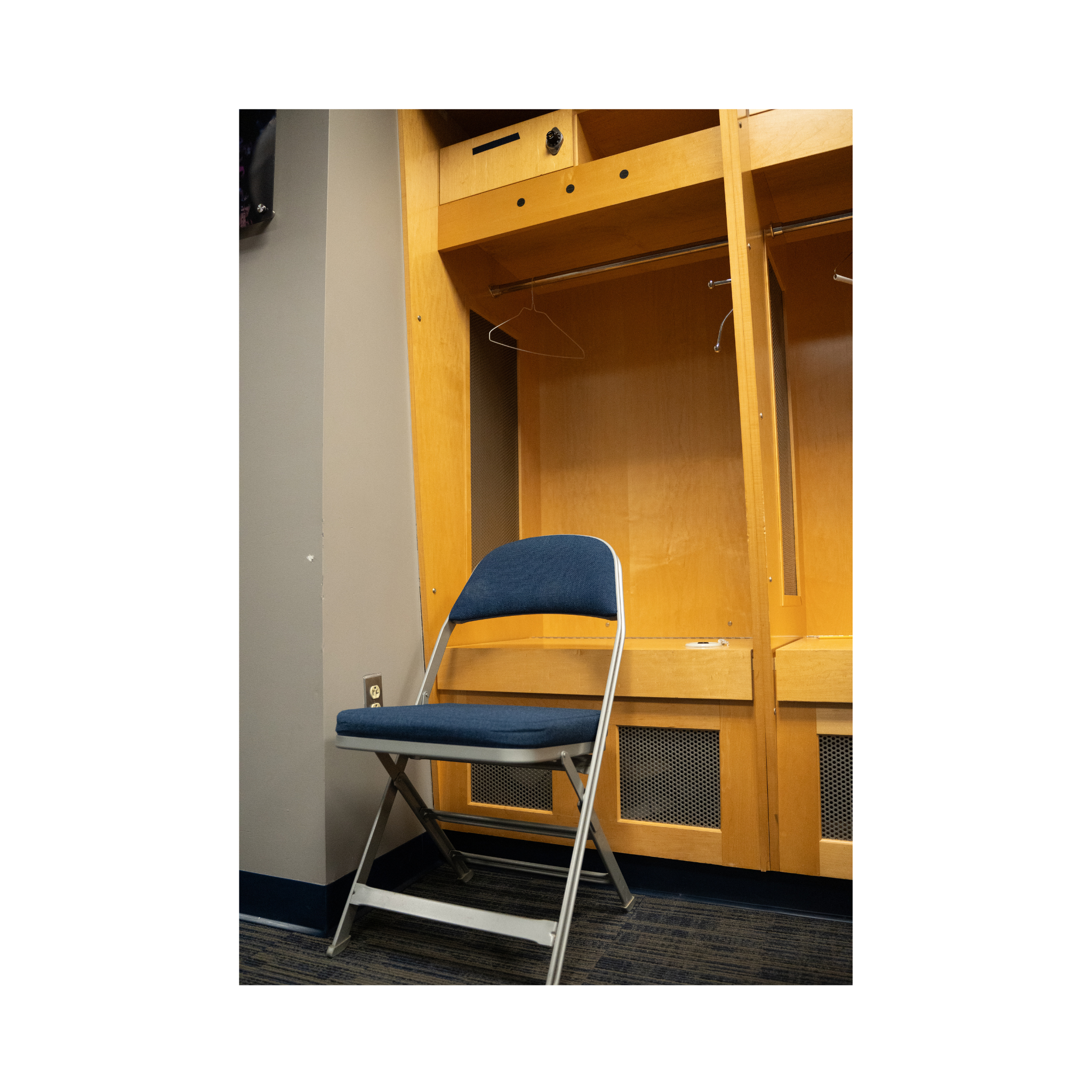 Blue UConn chair in front of a wooden basketball locker